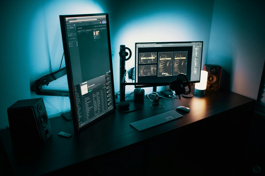 pexels photo 1714208 1714208 A contemporary office desk featuring a dual monitor setup with stylish lighting, ideal for tech enthusiasts.
